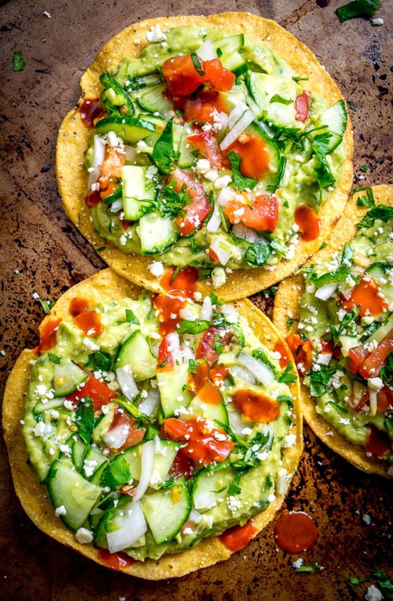 These Avocado Hummus and Cucumber Pico de Gallo Tostadas are a vegetarian delight that can be prepared in only 15 minutes and requires no cooking time.