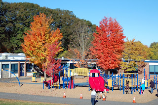 the playground is set for a New England autumn scene