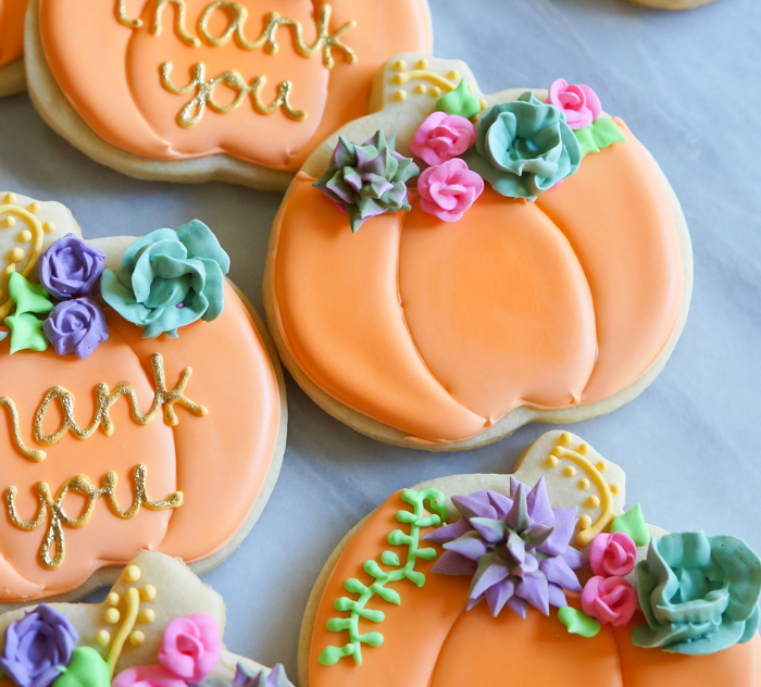decorated pumpkin cookies with royal icing succulents and roses