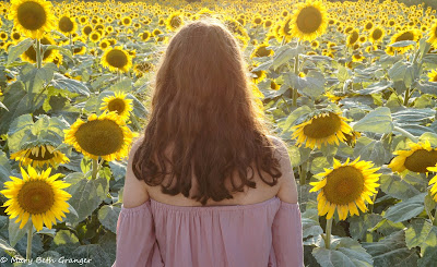 girl in the midst of sunflowers photo by mbgphoto