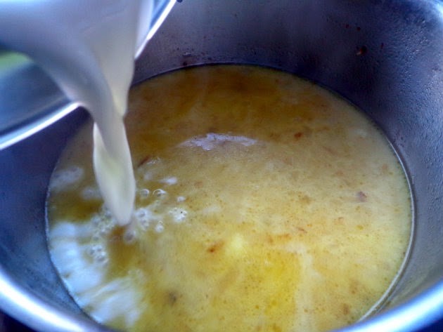 Pour in the milk and bring up to a simmer