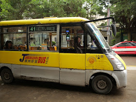 mini-mini Jumbo Wuzhou Bus with two passengers