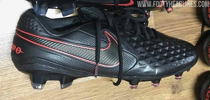 grey and red nike soccer cleats