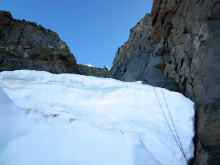 Back at the bergschrund and preparing to rappel over it.