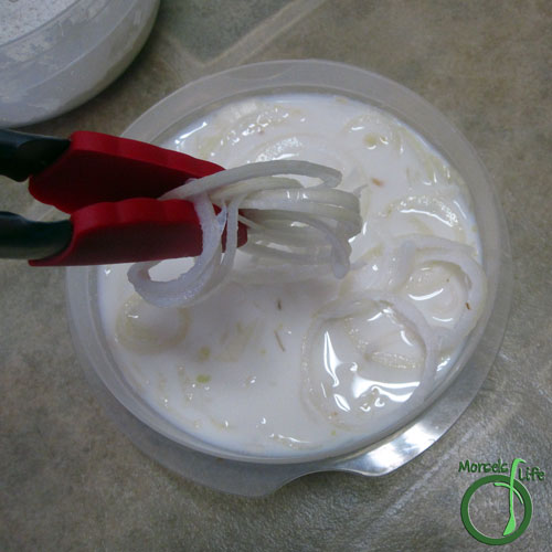 Morsels of Life - Onion Strings Step 4 - Remove onion rings from buttermilk, making sure most of the buttermilk drips off.