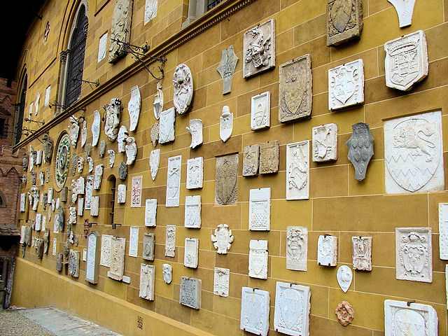 Enormous collection of family crests adorn the rear exterior walls of the Stibbert Villa.