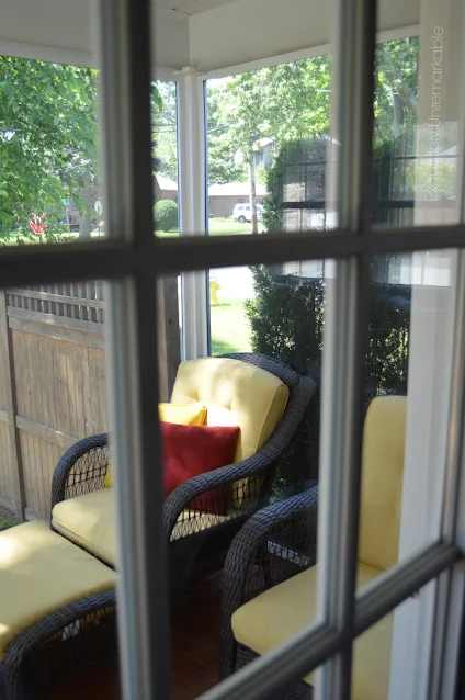 View of summer porch through a window pane from inside the house