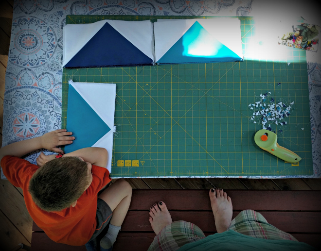 The flying geese quilt blocks are four shades of blue. The flying geese quilt blocks are four shades of blue.