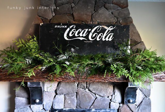 Coca Cola inspired Christmas fireplace mantel decorating with stars - via : https://www.funkyjunkinteriors.net/