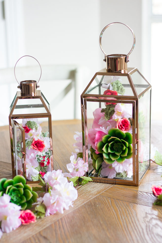 Make these gorgeous floral topiary spring lanterns with faux flowers and foam cones! Make these gorgeous floral topiary spring lanterns with faux flowers and foam cones!