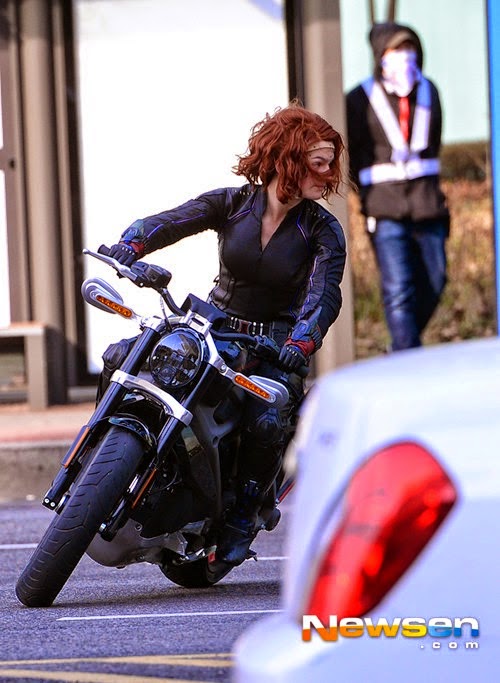 Scarlett Johansson as Black Widow riding an electric motorcycle