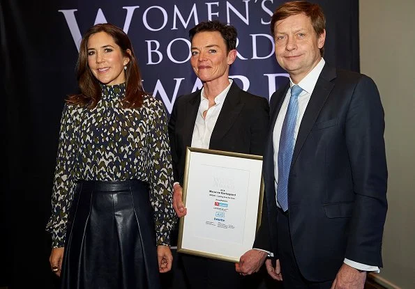 Danish Crown Princess Mary to the winner of the award, CSM's President Marianne Kirkegaard. Princess Mary wore leather skirt and print blouse