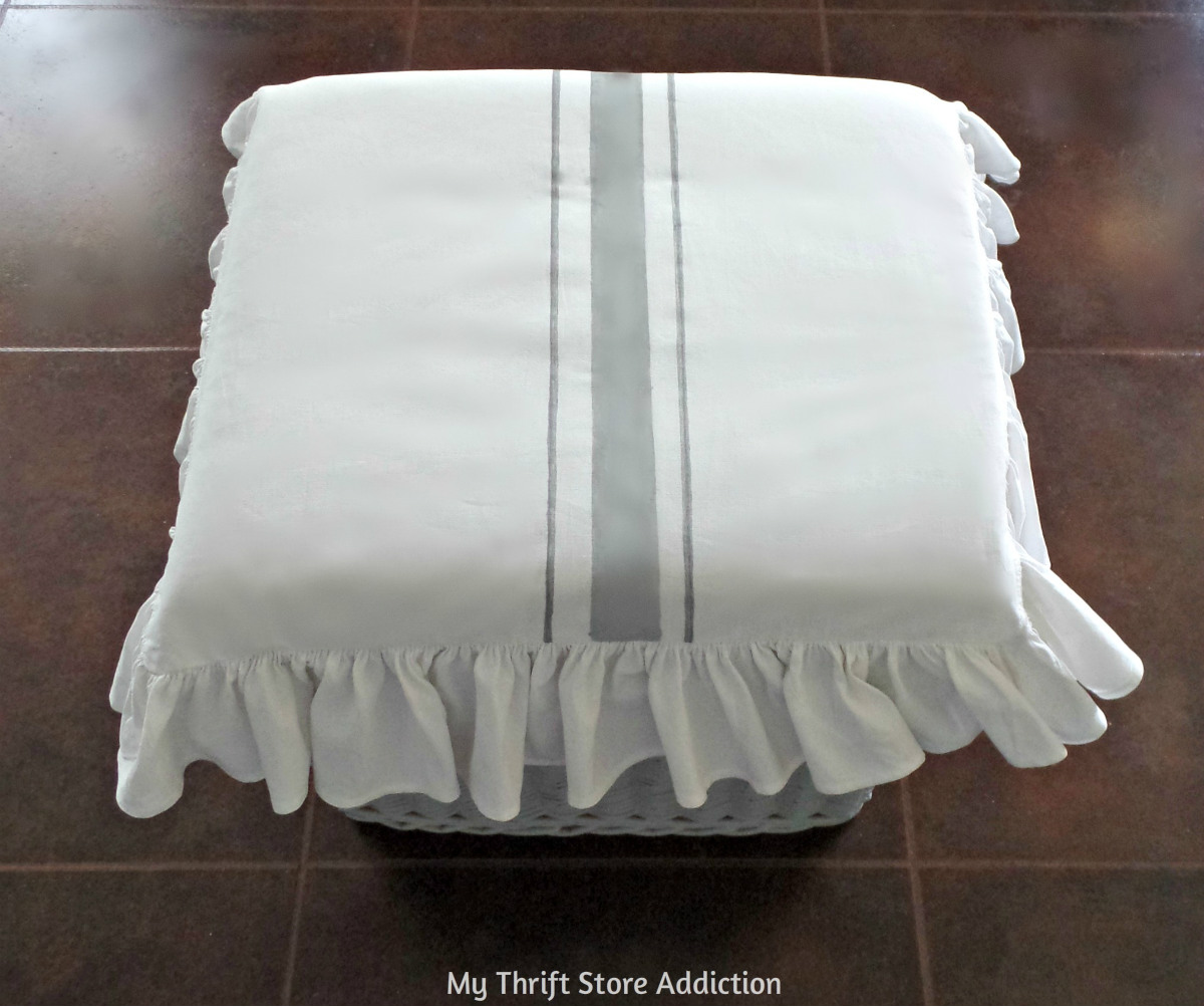 How to create a comfortable footstool with a grain sack stripe cushion that's the perfect height for short girls and a pretty storage option even if you're tall! DIY short girl footstool with grain sack stripe cushion
