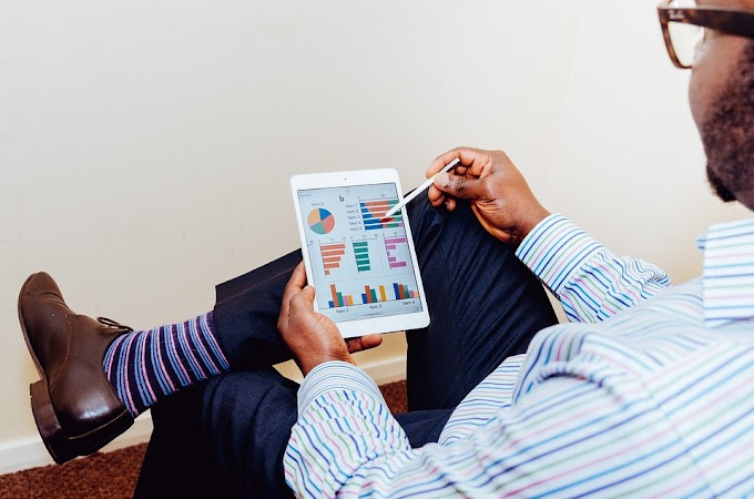 Business man analyzing graphs on a tablet