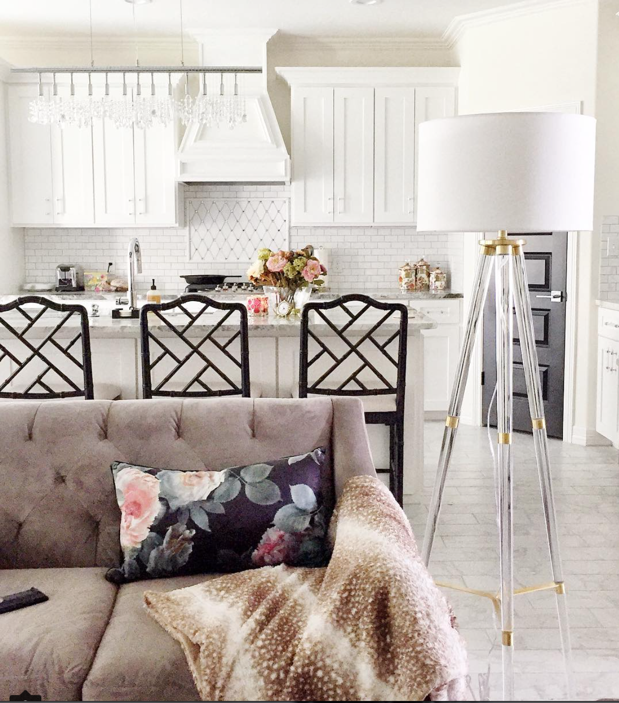 White shaker kitchen cabinets, black chinoiserie Dayna stools, tufted gray sofa, and lucite floor lamp in a gorgeous home! | via monicawantsit.com