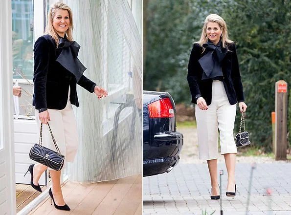 Dutch Queen Maxima wore a Natan velvet blazer and Natan silk blouse. Natan is a Belgian fashion house founded by Edouard Vermeulen