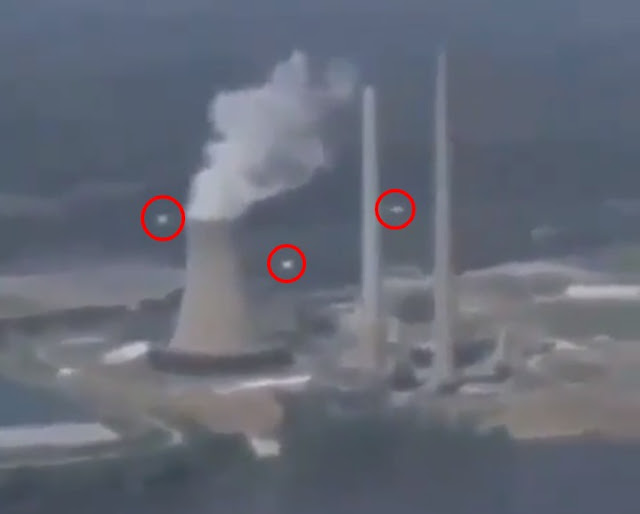 Lots-of-white-UFO-Orbs-surrounding-a-nuclear-power-plant.
