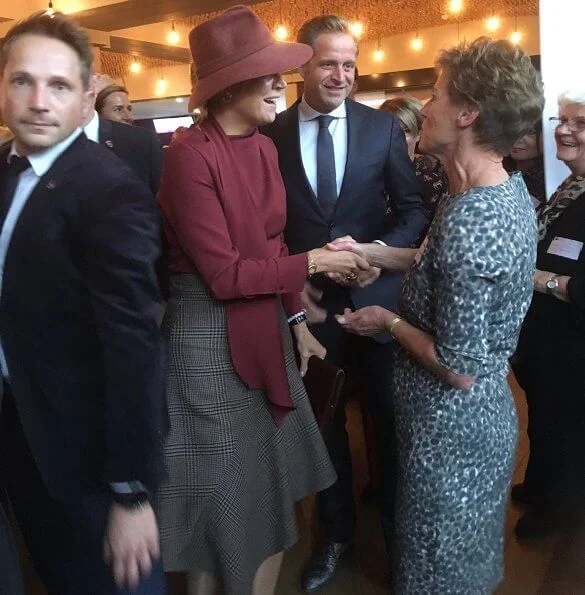 Queen Mathilde wore asymmetric midi skirts and Natan red blouse, Gianvito Rossi bicolor suede pumps, Fabienne Delvigne hat