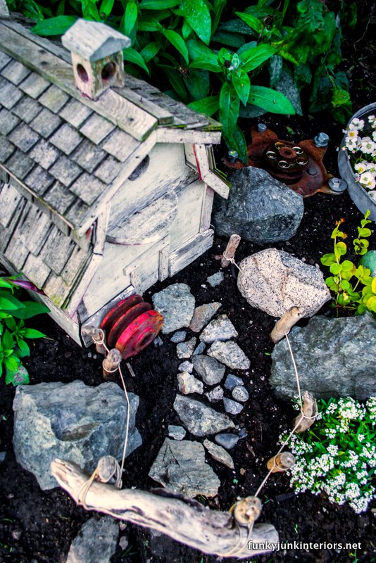 Rock walkways guide you to this farm-styled fairy garden with a barn birdhouse! Rock walkways guide you to this farm-styled fairy garden with a barn birdhouse!