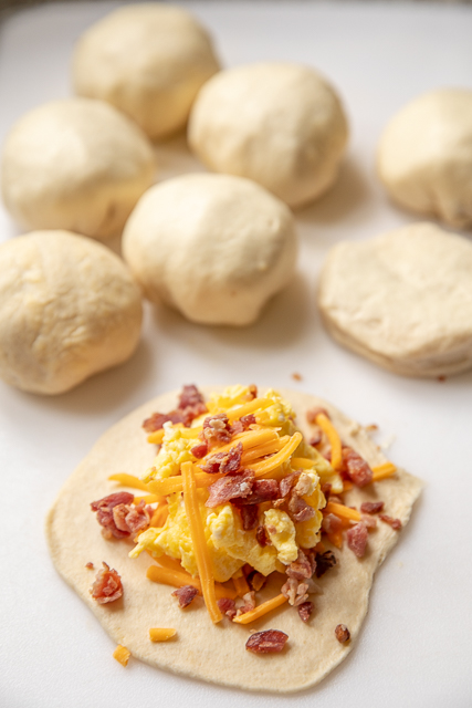 Glazed Breakfast Biscuit Bombs - the best way to start the day! Biscuits stuffed with scrambled eggs, bacon and cheese and topped with a sweet and savory glaze. We make these at least once a month! Refrigerated biscuits, milk, eggs, bacon, cheddar cheese, butter, brown sugar, dijon mustard, Worcestershire sauce and poppy seeds. A great dish for breakfast, brunch and overnight guests! #breakfast #biscuits Glazed Breakfast Biscuit Bombs - the best way to start the day! Biscuits stuffed with scrambled eggs, bacon and cheese and topped with a sweet and savory glaze. We make these at least once a month! Refrigerated biscuits, milk, eggs, bacon, cheddar cheese, butter, brown sugar, dijon mustard, Worcestershire sauce and poppy seeds. A great dish for breakfast, brunch and overnight guests! #breakfast #biscuits