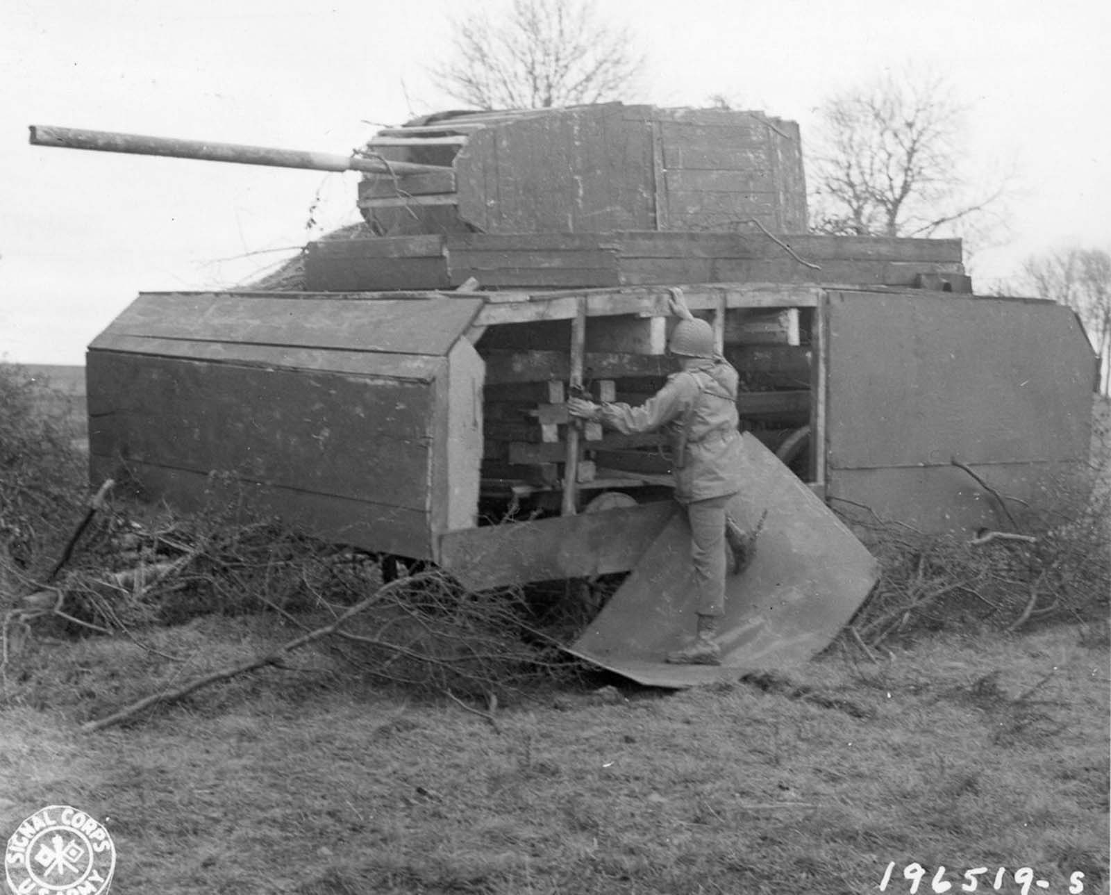 An American soldier inspects a German dummy tank in Metz, France. 1944.