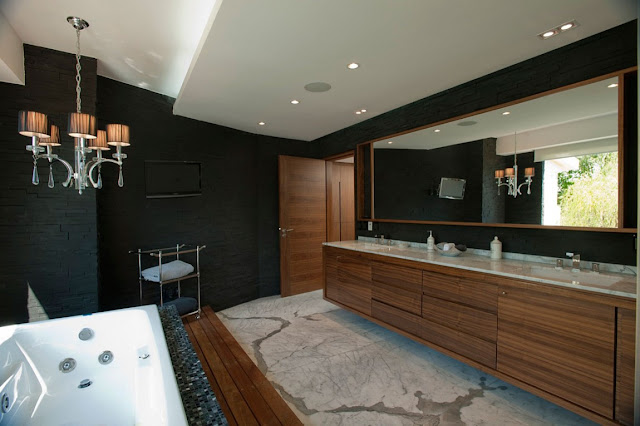 Modern bathroom with black walls and wooden furniture