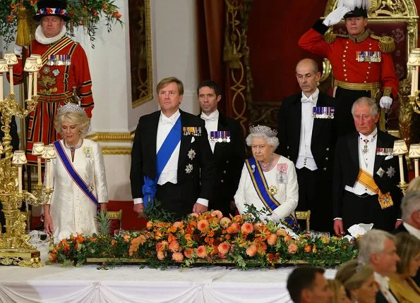 Kate Middleton's wearing the Lovers Knot Tiara, Diana's Collingwood earrings and blue McQueen gown. Maxima' Jan Taminiau gown and pearl tiara