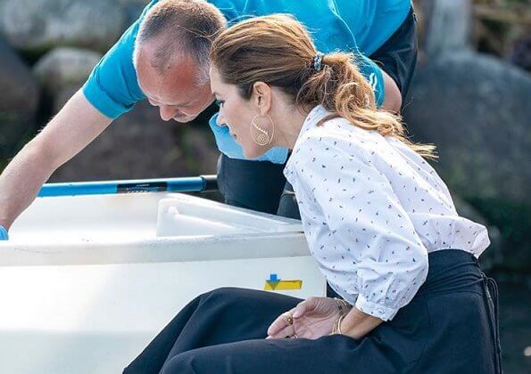 Crown Princess Mary wore a white printed shirt and black skirt. The thornback ray (Raja clavata) were released into Danish waters