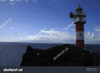 Lighthouse,Punta de Teno, on the Canary Island of Tenerife, giant moles of volcanic rock ending in the Atlantic Ocean, from blue waters are common whale sightings Lighthouse,Punta de Teno, on the Canary Island of Tenerife, giant moles of volcanic rock ending in the Atlantic Ocean, from blue waters are common whale sightings