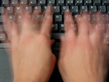 blurred typing fingers