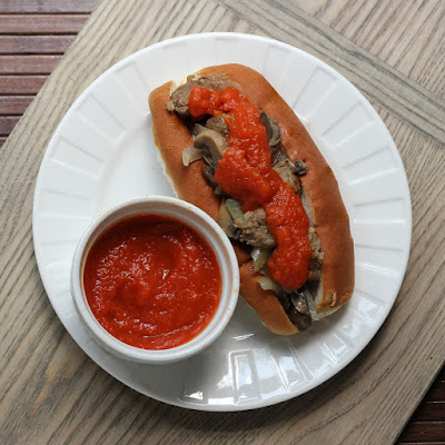 Roasted red pepper spread on Italian sausage sandwiches.