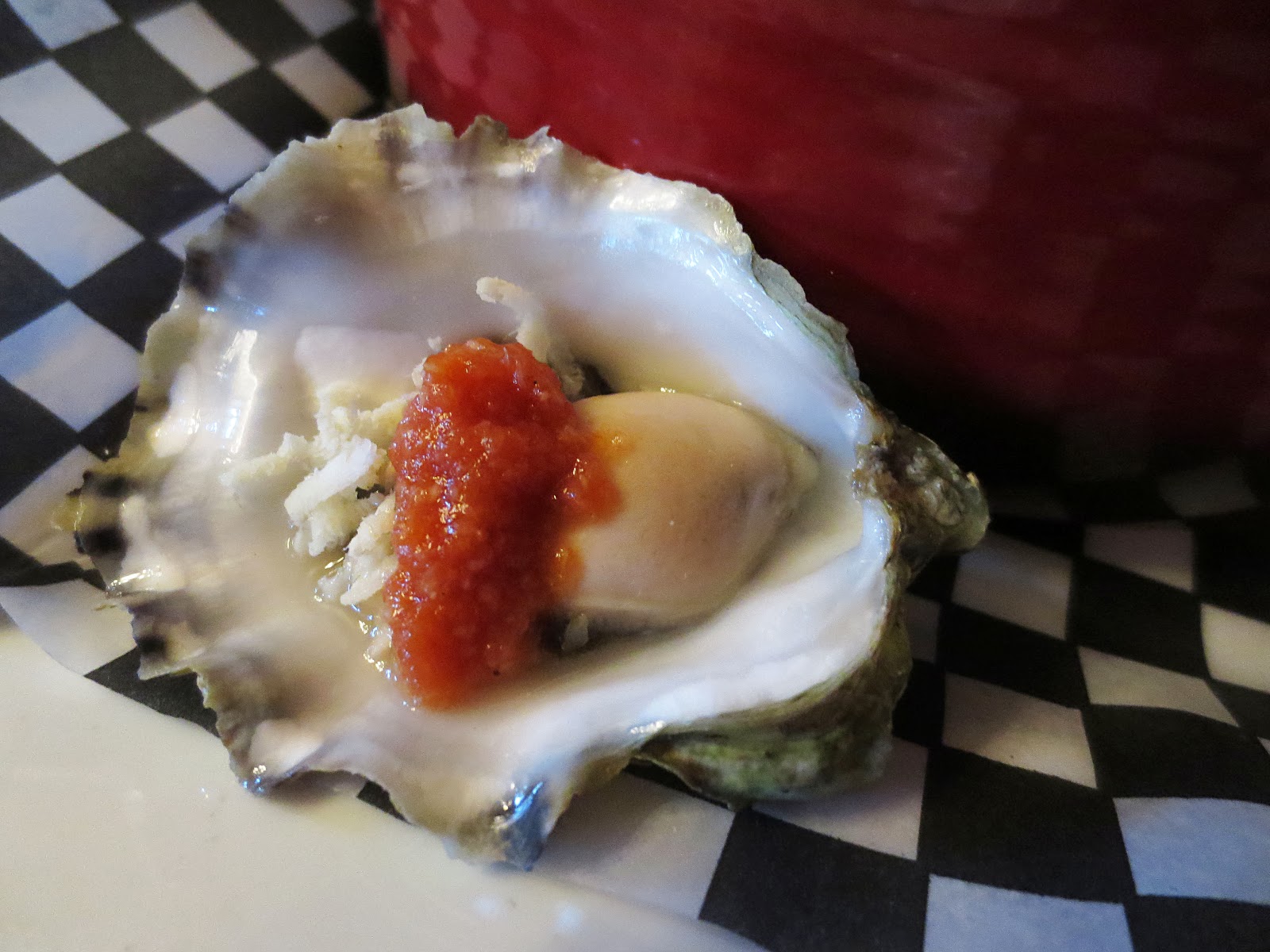 Raw oyster with spicy salsa and freshly graded horseradish