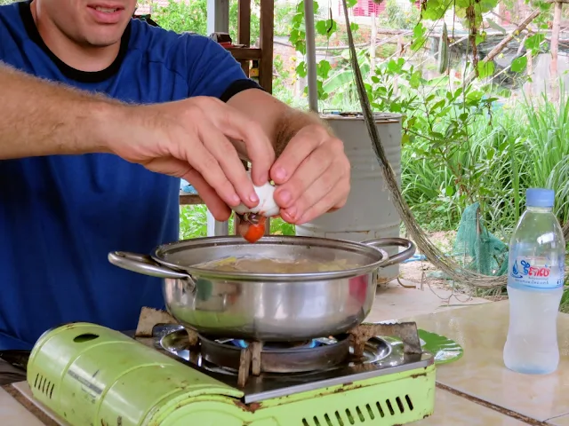 Adding a balut to Muscovy Duck Soup on a Street Food Tour in Siem Reap Cambodia