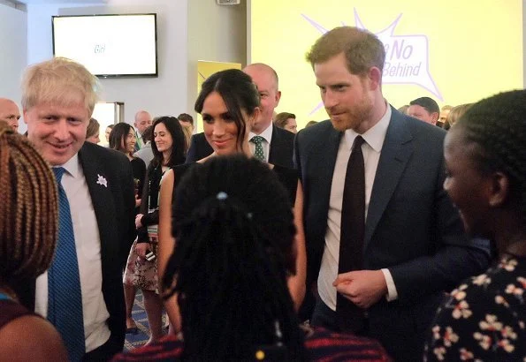 Meghan Markle Wore Black Halo Jackie Belted Dress and Gucci clutch and Aquazurra ankle-strap heels. Prince Harry, Foreign Secretary Boris Johnson