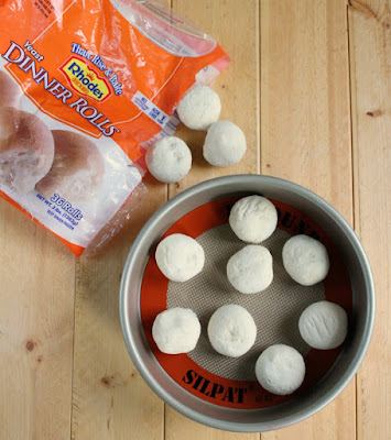 rhodes frozen rolls arranged on silpat in pan to defrost