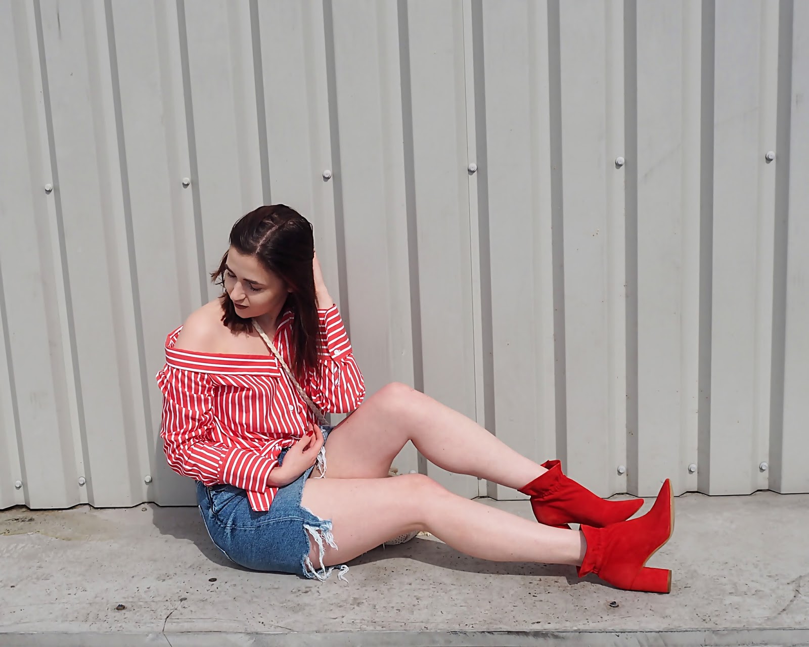 red shirt and boots sitting