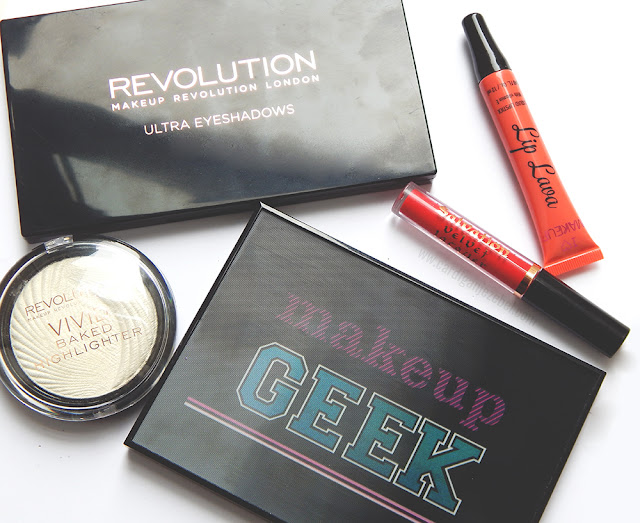 Close up of Makeup Revolution palettes, highlighter and lip products.