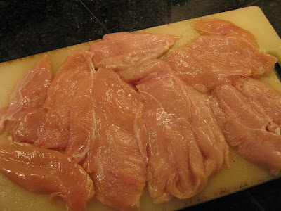several chicken breasts on cutting board
