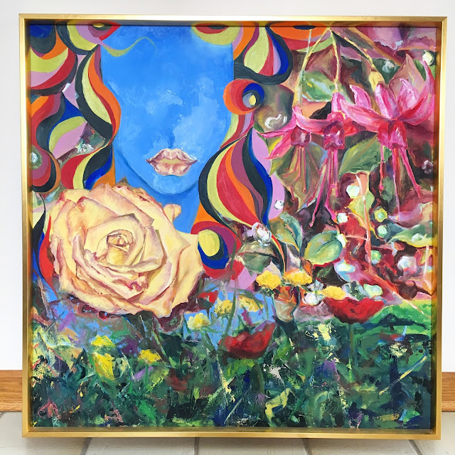 [Image of a square painting framed in gold. A blue face is in the upper left corner reminiscent of the sky. Her lips mimic the color and strokes of the rose below. Her hair is in bold color waves. To the upper right are fuschia flowers. Along the bottom are yellow and red flowers among greenery painted with a combination of brushes and a palette knife. The painting is colorful, mood is bright and organic.]