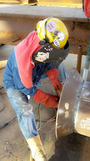 female welder tyra doing an weld joint