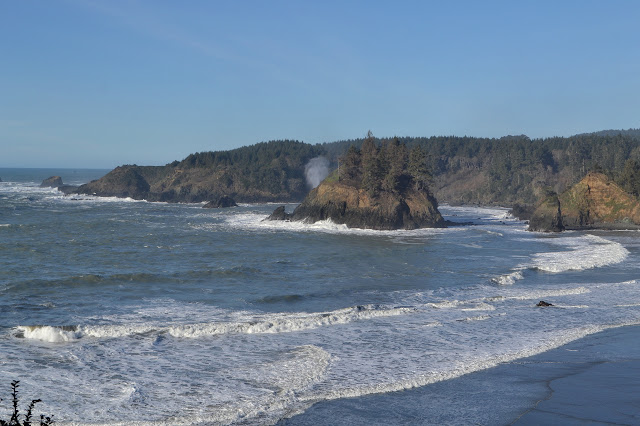 actual island with a spout of water behind