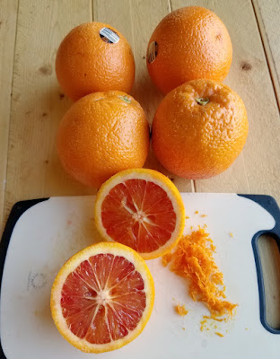 inside of blood orange halves with additional oranges in background