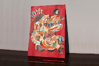Photo of'Shell' artwork by Kostas Gogas for size comparison beside a colored a pencil.