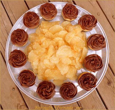 Fluffernutter Cupcakes, reminiscent of a favorite New England sandwich. A peanut butter cupcake with a marshmallow fluff center. Add a chocolate frosting, and you've got dessert. | Recipe developed by www.BakingInATornado.com | #recipe #cupcake