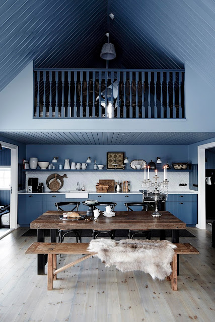 A black cottage in Iceland decorated in blue-grey tones