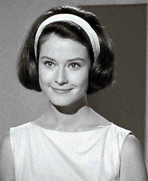 Diane Baker as Carol. 