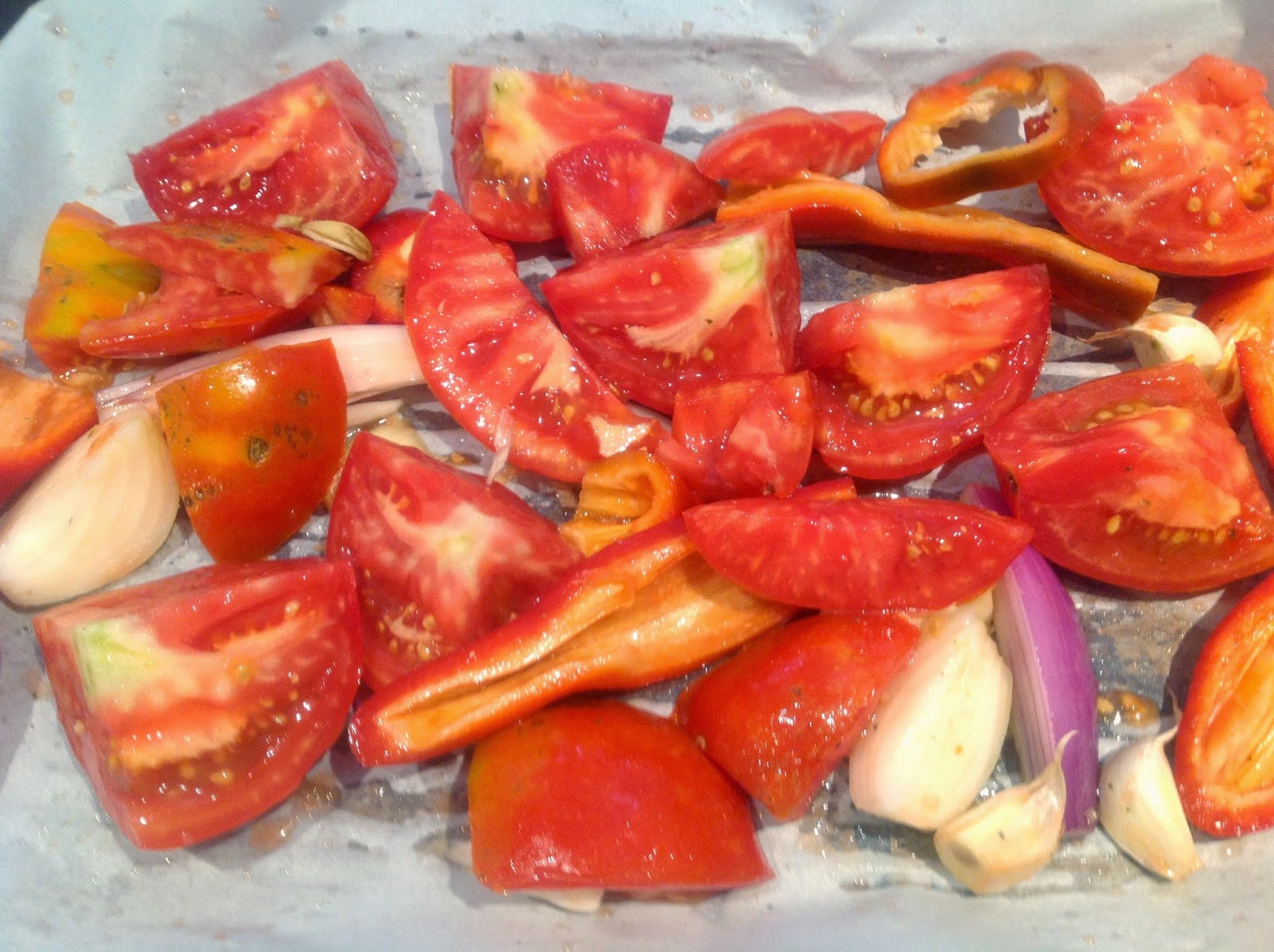 quartered tomatoes on a cookie sheet