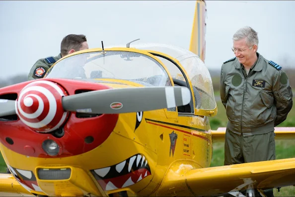 Belgium's King Philippe looks at a SIAI-Marchetti SF260 training aircraft during his visit to the Beauvechain Air Base 