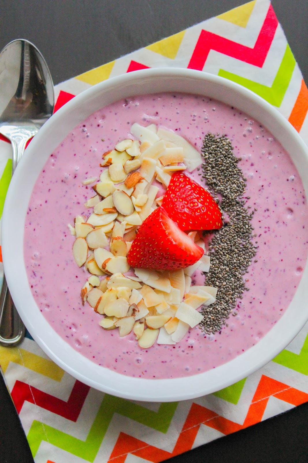 Mixed Berry Smoothie Bowl with Toasted Coconut Chips and Almonds
