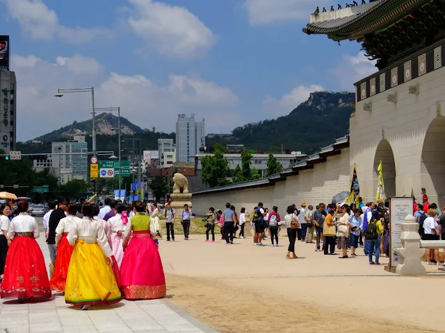 Visitors in period costume outside Gyeongbokgung Palace in Seoul South Korea